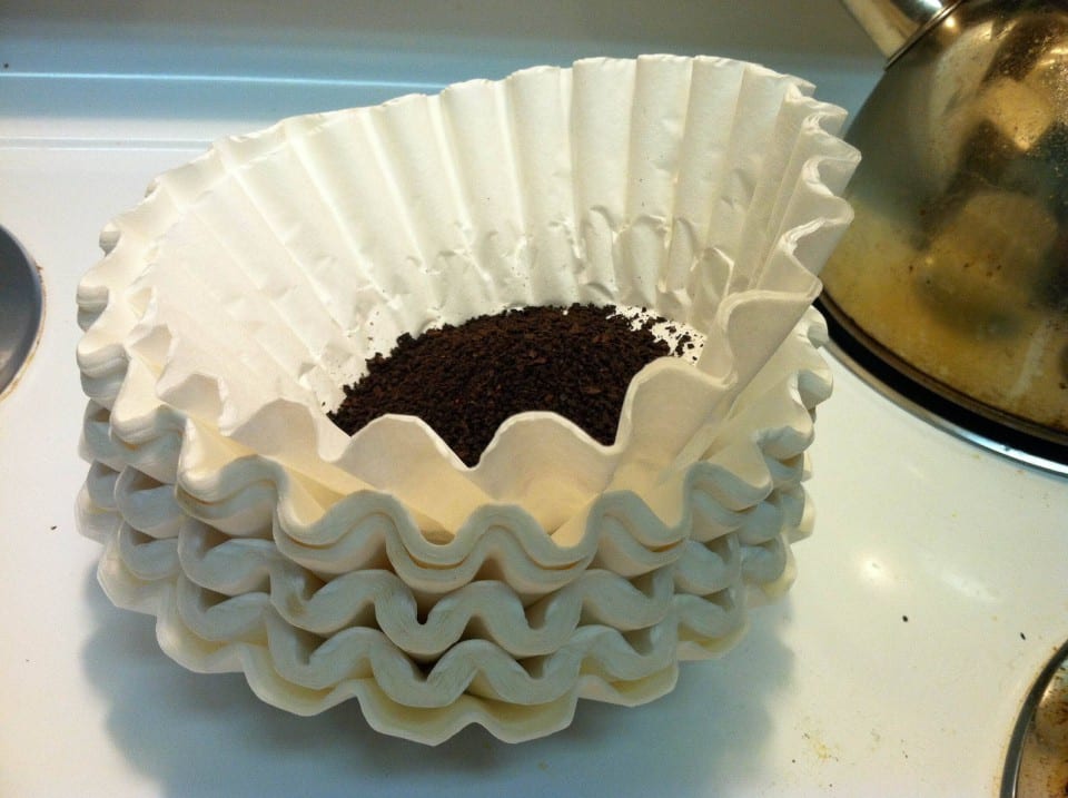 Coffee grounds in a pile of coffee filters